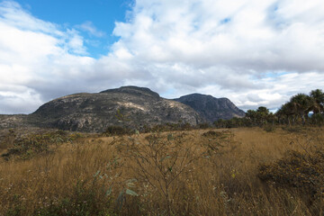 Beautiful mountain with vegetation and clouds in the sky. Broadleaf, Botumirim, Minas Gerais, Brazil.