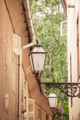 Selective blur on a Vintage old public lamp, typical lantern from the 19th century, on zakmardijeve stube Street, a picturesque medieval and narrow street of Gornji Grad district in Zagreb, Croatia.