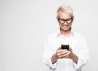 Photo of elderly woman wearing glasses use smartphone