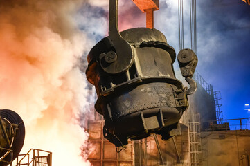 The metallurgical bucket hangs on a special crane beam