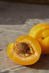 yellow fresh apricots half of the fruit with a stone in the foreground