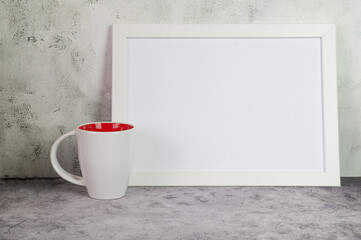 Minimalist interior with white mug and photo frame mockup