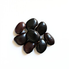 Black fava bean seeds on a white background