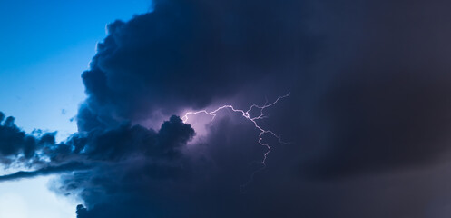 Lightning strike in dark storm clouds weather and nature background