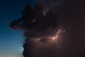 Lightning bolt in dramatic storm clouds nature and landscape background. Lightning storm and purple...