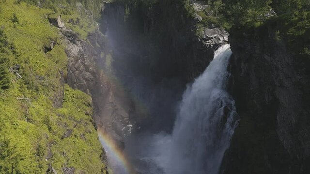 upper view of Hallingsafallet waterfall in Ostersund, Sweden, on sunny day in summer. Slowmotion tilt up