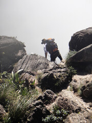 person jumping on a rock