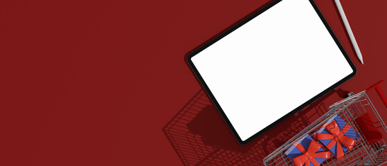 Top view of digital tablet with mock-up screen composing with cart and gift boxes on red background