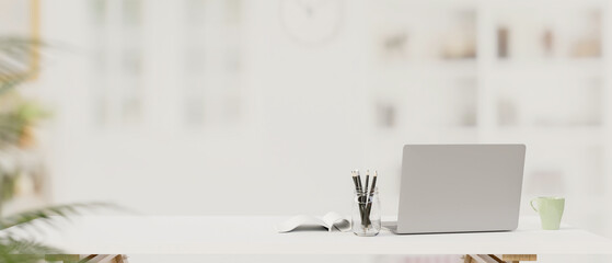 Laptop, stationery and copy space on the table with blur background, 3D rendering