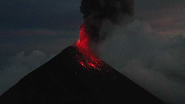 Guatemala volcano Fuego eruption aerial drone 4K video. Fly over Fuego volcano crater, beautiful sunset scenery.Red Lava. Aerial panorama shot