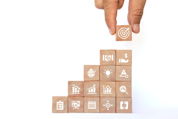 Hand picked wooden blocks with vertically arranged business icons as per the action plan. goals and goals Success Concepts and Business Goals project management business strategy development