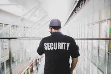 Security guard in uniform patrolling in a commercial building