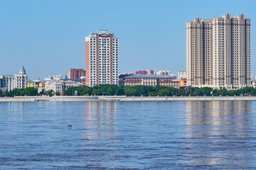 View of the embankment of the neighboring town of the neighboring country from the city of Blagoveshchensk, Russia. Flood period.