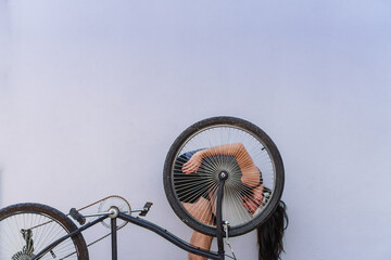 young hispanic latino long-haired man with his upside down bike