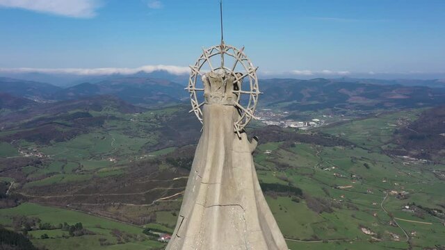 Aerial drone view of a large monument statue of the Virgin of Ordu&ntilde;a on the top of Mount Txarlazo in the Basque Country