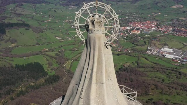 Aerial drone view of a large monument statue of the Virgin of Ordu&ntilde;a on the top of Mount Txarlazo in the Basque Country