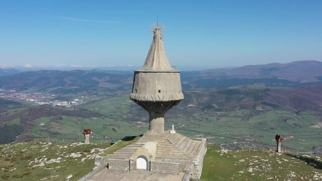 Aerial drone view of a large monument statue of the Virgin of Ordu&ntilde;a on the top of Mount Txarlazo in the Basque Country