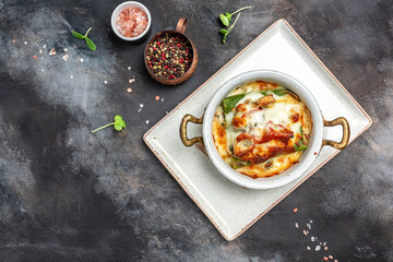 hot spinach pancakes crepe with chicken and mushrooms baked with cheese. banner, menu, recipe place for text, top view