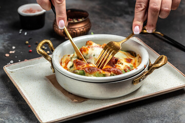 Savory homemade mushroom, chicken and spinach crepes baked with cheese. Healthy food trend. top view