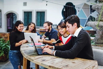 Fototapeta premium Group of young latin college students developing a project at the university in Mexico