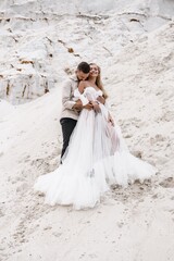 Beautiful wedding couple bride and groom at wedding day outdoors at ocean beach. Happy marriage couple o