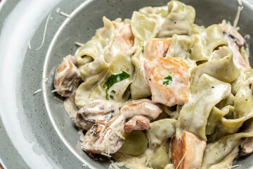 Pasta with chicken and cream mushroom sauce. Tagliatelle pasta. Traditional Italian cuisine. Food recipe background. Close up