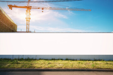 White blank hoarding poster with mockup space on construction site - obrazy, fototapety, plakaty