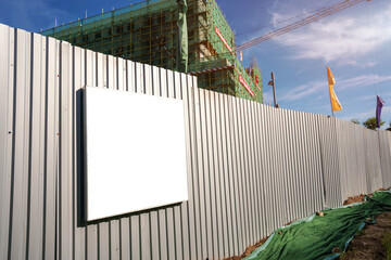 Empty white information frame with space for mock up hangs on metal fence