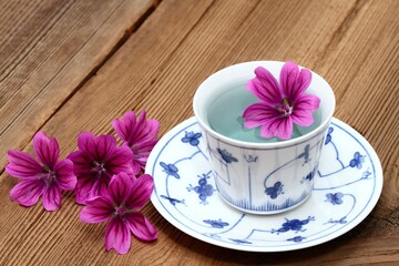 Herbal tea from fresh flowers of  Wild mallow, lat.  Malva sylvestris. Medicinal herb has been used in herbal medicine.  Good against cough and inflammation.
