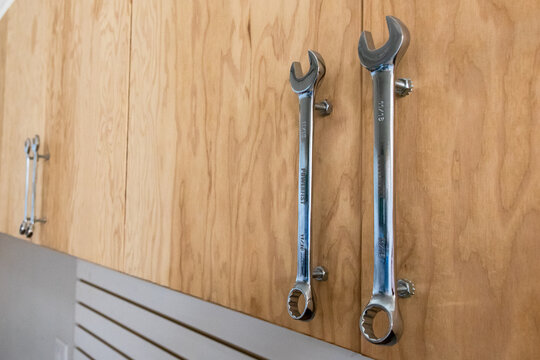 Garage cabinets with wrenches for door pulls.