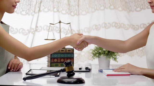 Judges or lawyers agree on a ruling or agreement that provides justice and fairness - shakes hands on the solution