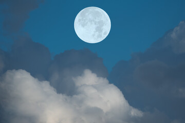 Fototapeta na wymiar Full moon and clouds on the sky.