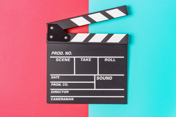 Fototapeta na wymiar The clapperboard on blue and red background close-up, top view.