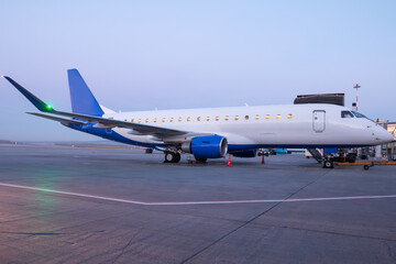 A passenger aircraft parked by the boarding bridge