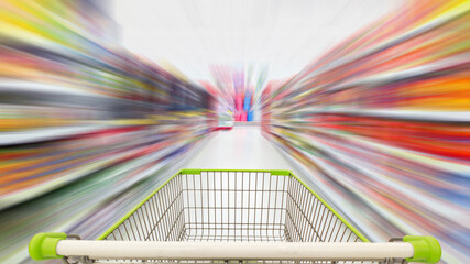Supermarket aisle with empty green shopping cart