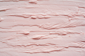 Gently pink smear and texture of face cream or acrylic paint isolated on white background