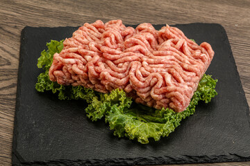 Raw pork minced meat over board