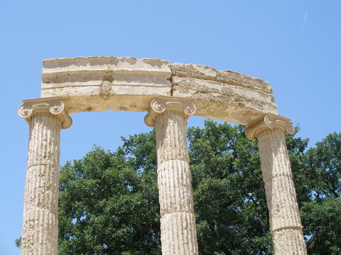 corinthian columns in the ancient philippeion temple  in the altis in olympia, greece, on a sunny day