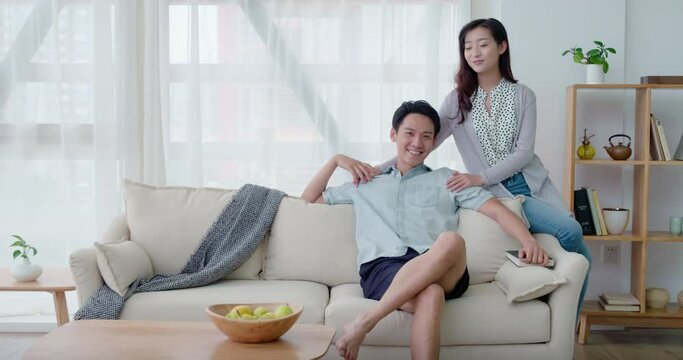 Happy young couple sitting on sofa,4K