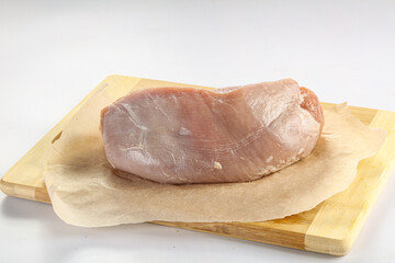 Raw pork fillet over board