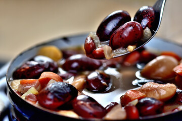 Close-up of bean soup with large beans in an old enamel pot