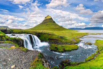 landscape view of Kirkjufellsfoss In the daytime, blue sky and beautiful clouds. The waterfall is famous and a popular tourist spot in Iceland.