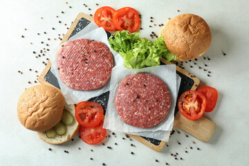 Concept of cooking burger on white textured table