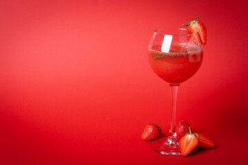 Alcoholic cocktail Rossini and ingredients on red background