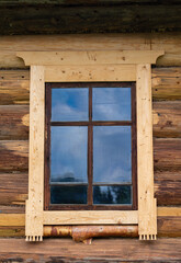 Small window in the wall of an old wooden house. Old history house