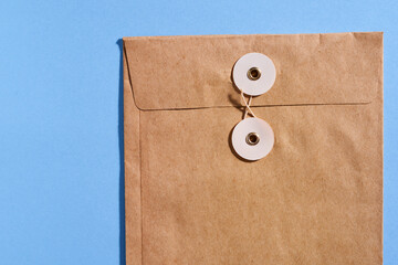 close up of brown envelope on the blue background