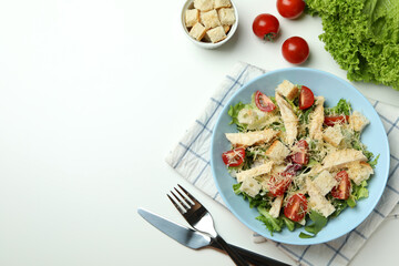 Concept of tasty eating with Caesar salad on white background