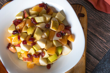Organic vegan Fruit salad of papaya apple kiwi banana pomegranate raisins for healthy lifestyle...