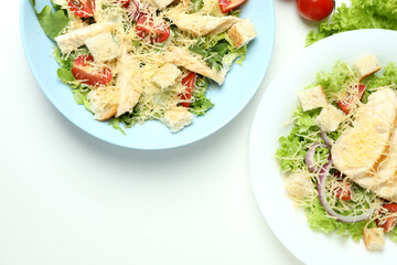 Concept of tasty eating with Caesar salad on white background