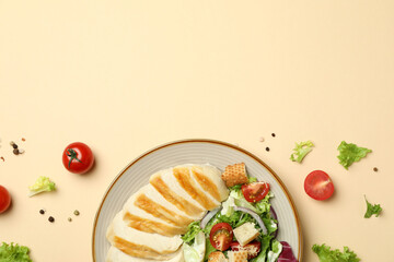 Concept of tasty eating with Caesar salad on beige background